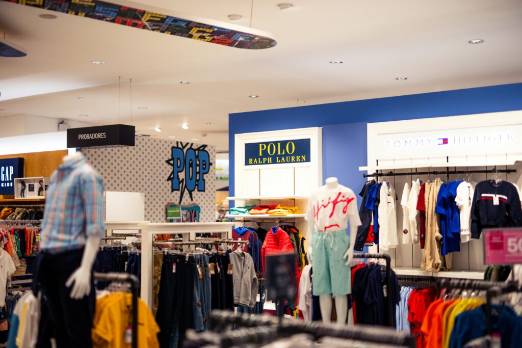 Vibrant clothing display at a modern retail store with mannequins featuring popular fashion brands.